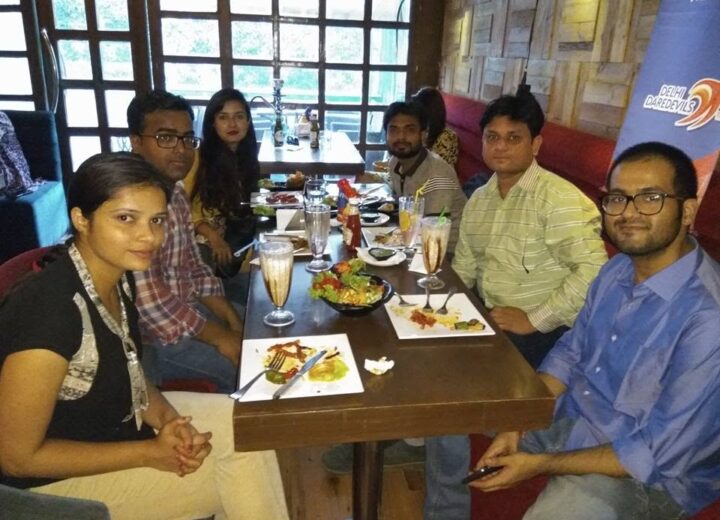 Influencers enjoying the Restromark Blogger Meetup at The OTB Cafe, Khan Market with food, lights, and laughter.